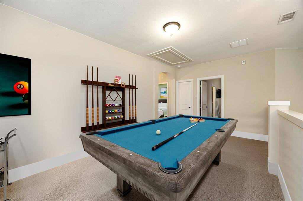 Come upstairs and enjoy a day of leisure in this fabulous game room/media room! This is the perfect hangout spot or adult game room, this space features plush carpet, high vaulted ceiling, recessed lighting, and custom paint. *Virtually Staged