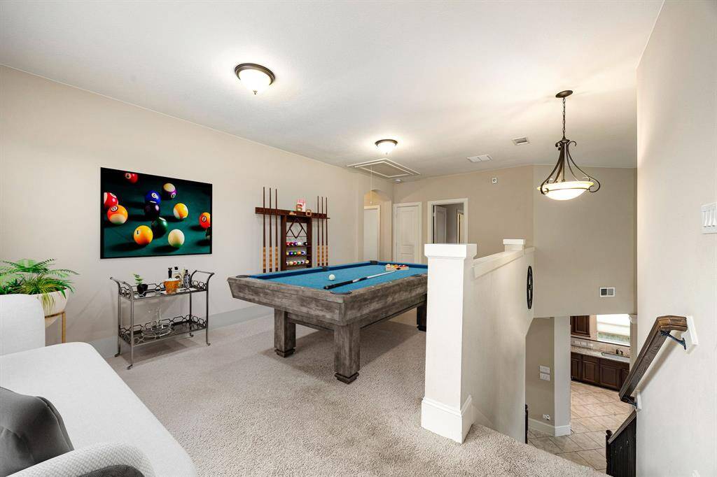 Head upstairs to unwind in this spacious game/media room—ideal for movie nights, game days, or relaxing with friends. This versatile space boasts plush carpeting, soaring vaulted ceilings, recessed lighting, and stylish custom paint for a cozy yet elevated vibe. *Virtually Staged