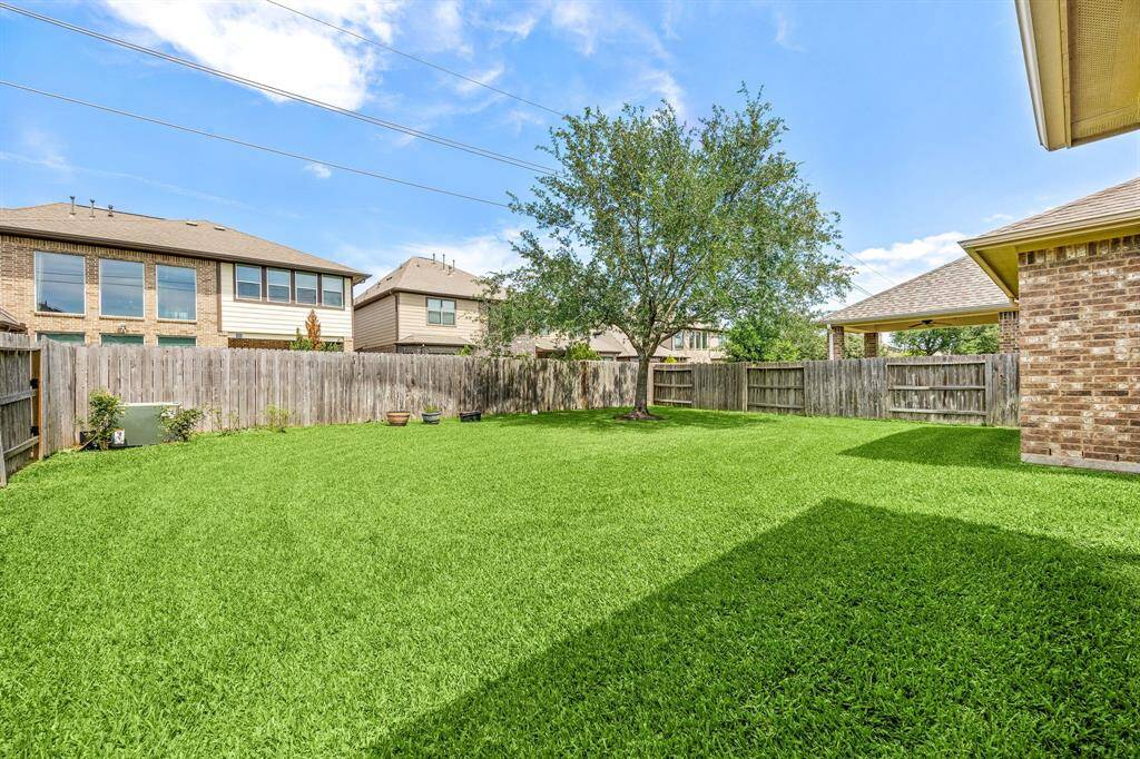 Fully fenced backyard offering privacy, plenty of green space, and room to create your dream outdoor retreat.