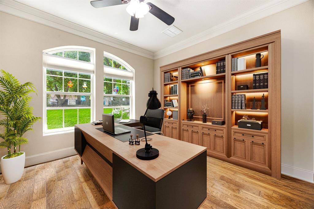 Nestled away quietly in the front of the home is the handsome and grand home office. Featuring high ceilings, crown molding, ceiling fan, custom paint, wood style flooring, and large windows with plenty of natrual light. *Virtually Staged
