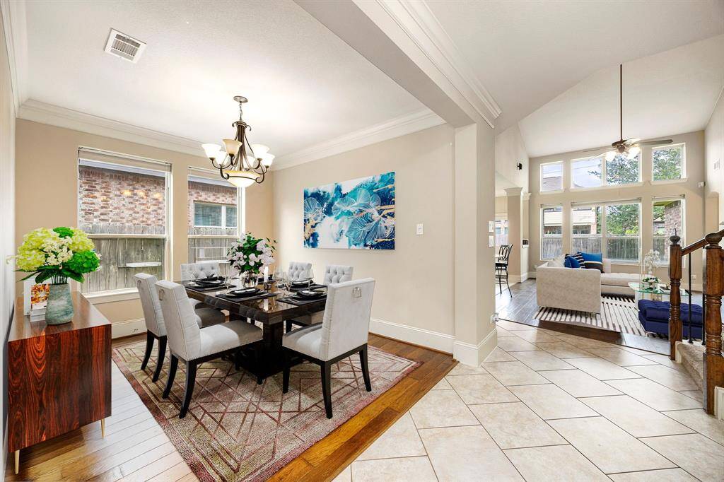 You and your guests will certainly dine in style in this amazing formal dining room! Featuring a gorgeous modern chandelier, large windows, neutral paint, high ceilings, crown molding, and wood style flooring. Perfect space to entertain family and friends. *Virtually Staged