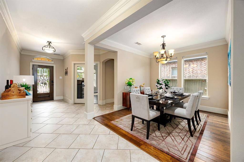 Make memories gathered around the table with your family and friends! This dining room features high ceilings, crown molding, chair rail, large windows, wood style flooring and a beautiful chandelier. *Virtually Staged
