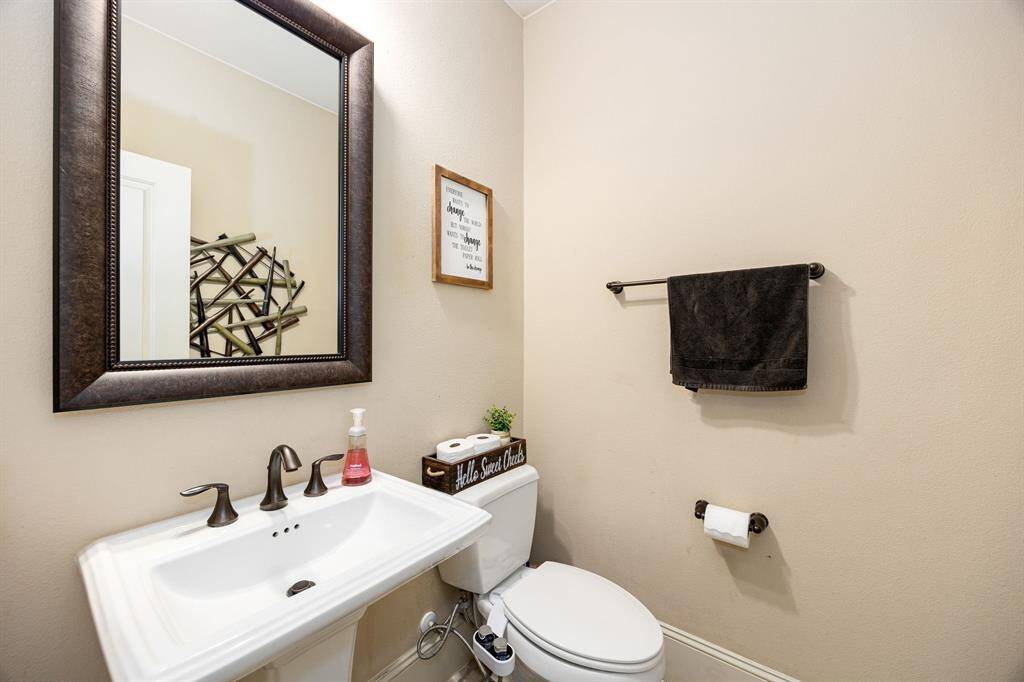 Modern half bath featuring sleek fixtures, stylish lighting, and custom finishes.