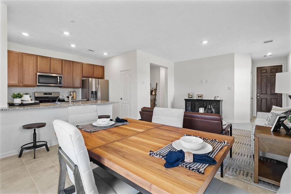 The open concept living room, dining, and kitchen makes for a great way to keep the party going and never miss a beat!