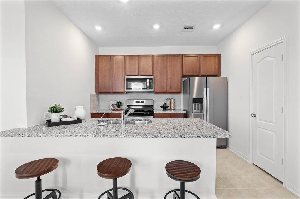 This stunning kitchen is perfect for everyday life as well as entertaining family and friends! Extra large breakfast bar is perfect for conversation or that much needed space to lay out your party spread for everyone to enjoy! Featuring stained cabinets, granite countertops, modern backsplash, stainless steel appliances, recessed lighting, and custom paint.