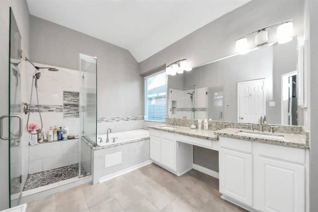 Master bathroom with shower and bathtub
