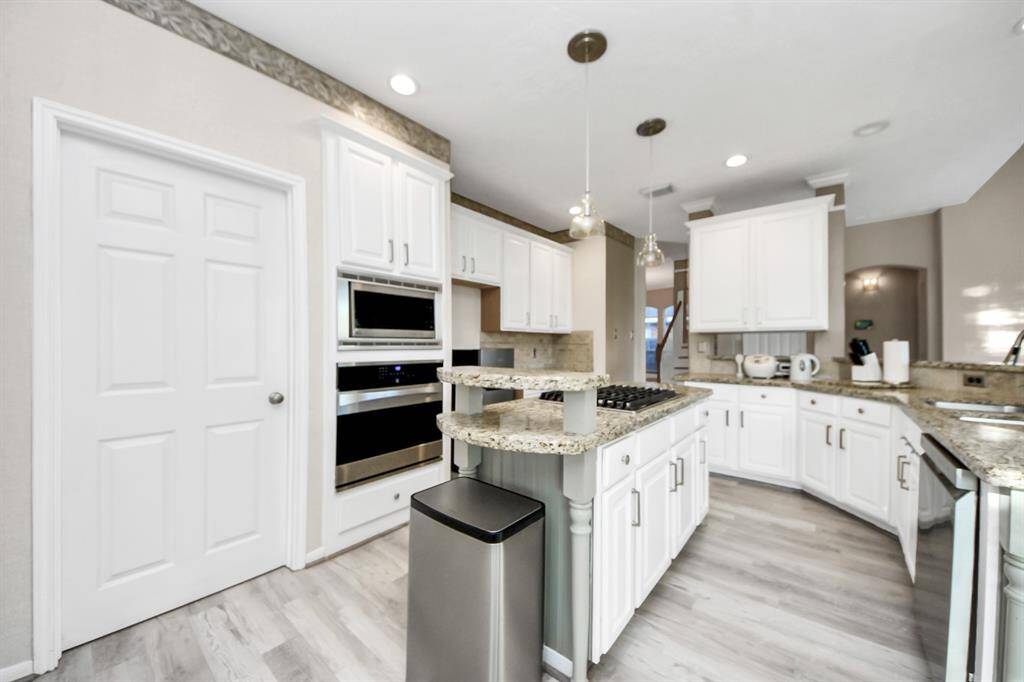 Kitchen with walk way to gargage
