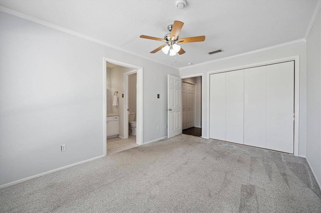 Secondary bedroom- includes a walk-in closet and an en-suite bathroom with modern fixtures.