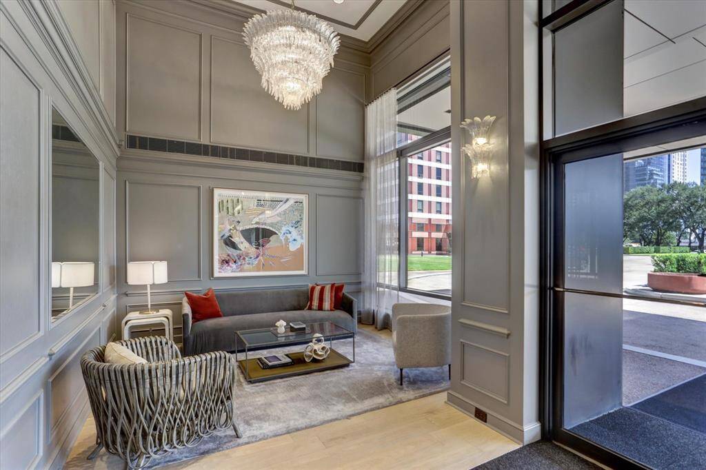 LIVING ROOM (28'x13') Floor to ceiling windows grace the entire south wall of the expansive Living Room/ Dining Room. White bamboo solar shades and custom lined drapery complete the decor.