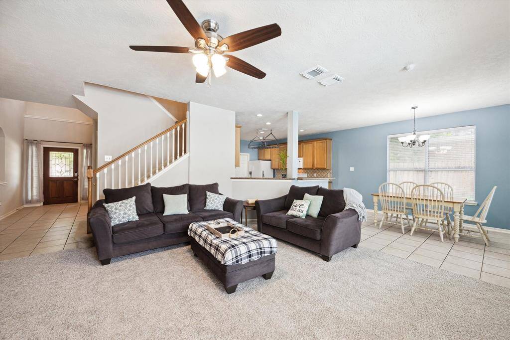 Living area opens to Breakfast room and Kitchen. Carpet was installed April 2025.