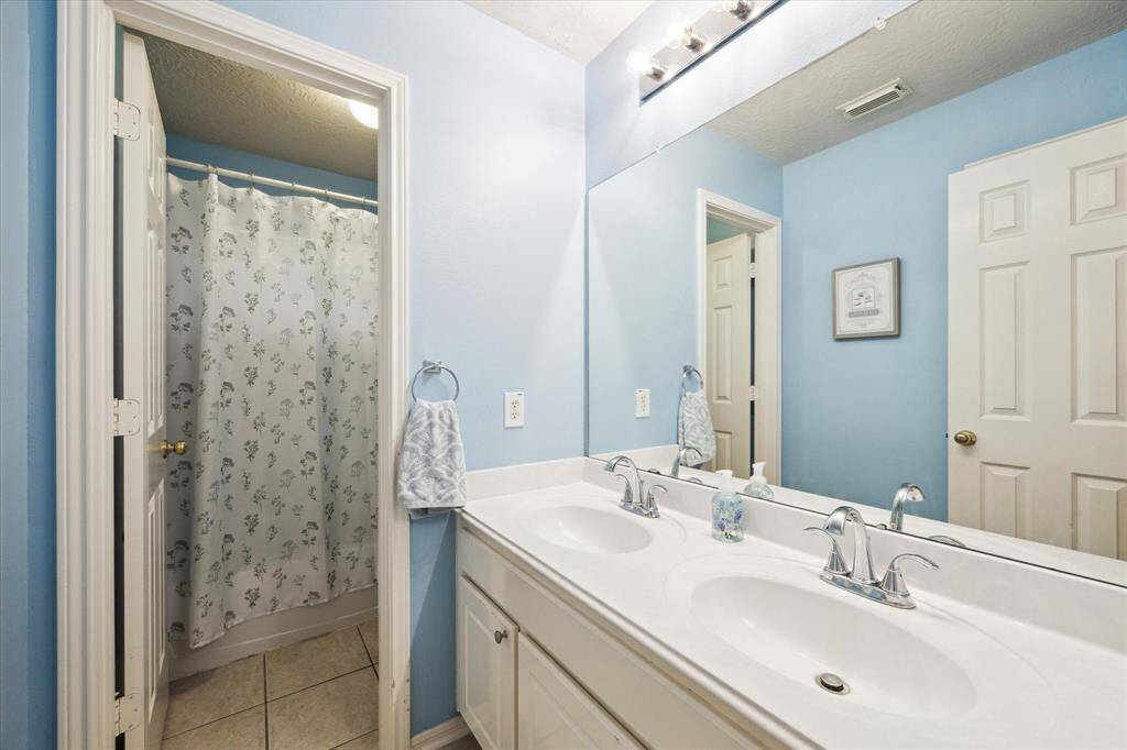Secondary bath with double sinks.