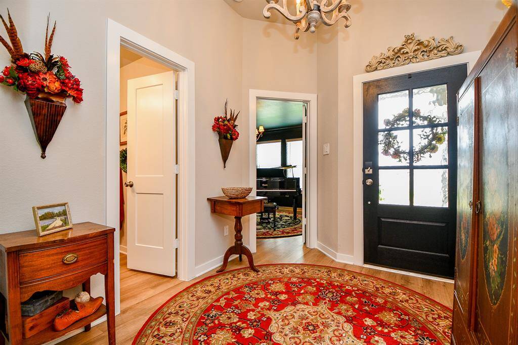 ENTRY WITH NEW LIGHT FIXTURE. A LOT OF THE FIXTURES IN THIS HOUSE HAVE ALREADY BEEN UPGRADED FROM THE BUILDER SELECTIONS