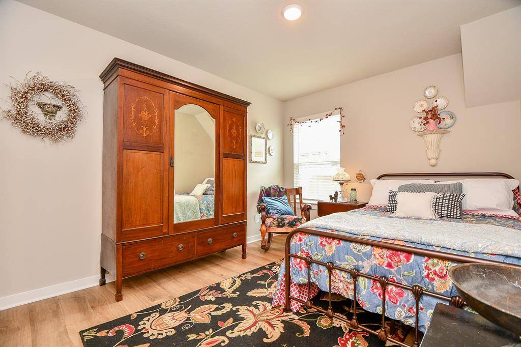 BEDROOM 3 IS LOCATED IN THE MIDDLE OF THE HOME WITH VINYL PLANK FLOORING AND RECESSED LIGHTING