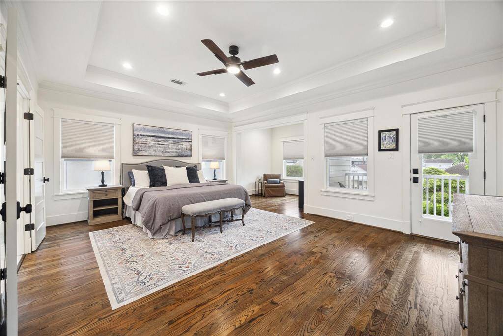 Natural light fills the room by day, while custom blackout shades on all windows ensure restful nights. Direct access to a balcony and sitting area completes the retreat.