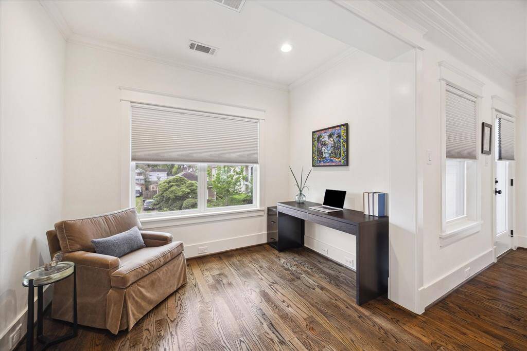 Flexible space in the primary bedroom makes a perfect home office, reading nook, or private lounge.
