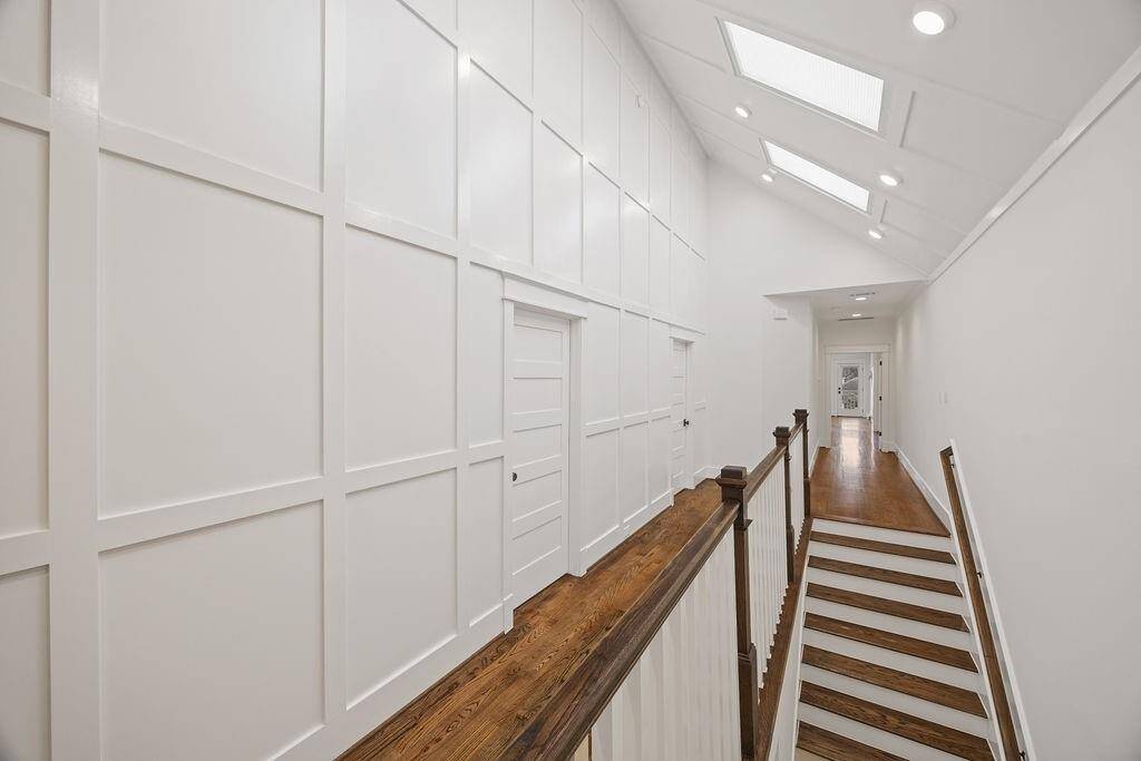 Who knew a hallway could be this good? Vaulted ceilings, skylights, and custom millwork make even your walk to the laundry room feel fancy.