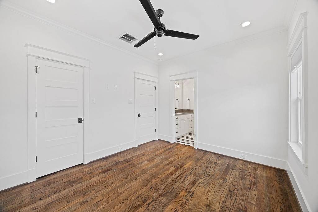 Bright and versatile, this fourth bedroom offers generous closet space and access to a shared en-suite bath.
