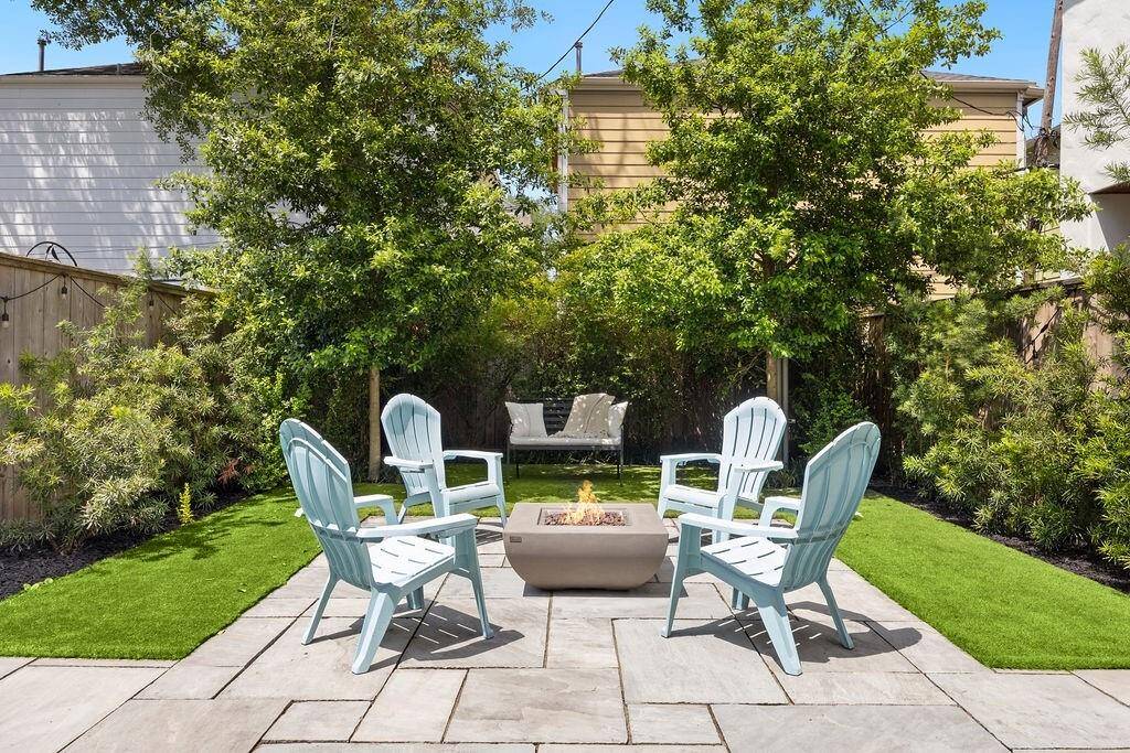 Lush landscaping and thoughtful design create a private backyard oasis.