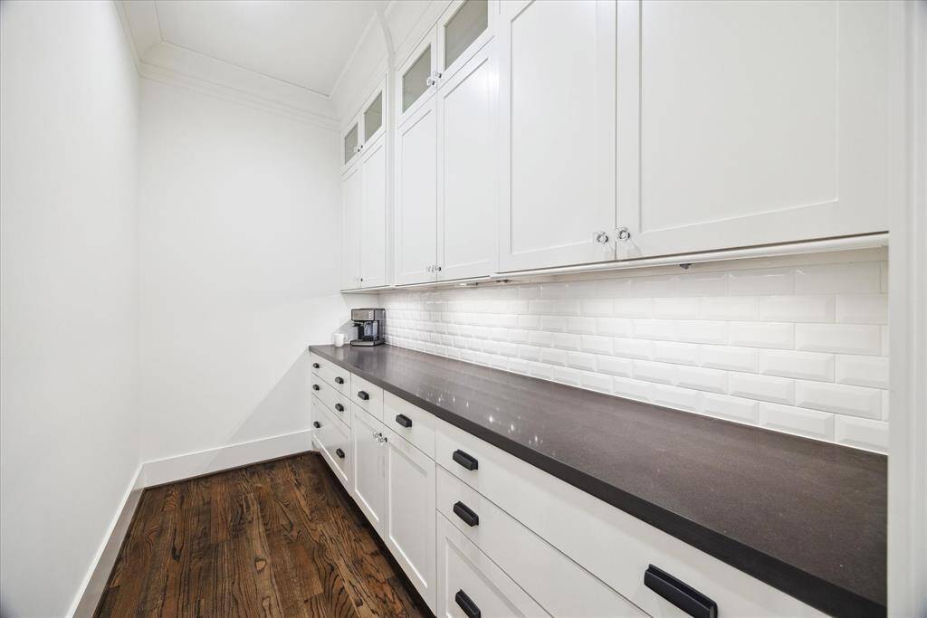 Tucked just off the kitchen, this generous butler’s pantry offers abundant cabinetry and prep space — the perfect spot for staging meals, storing serveware, or tucking away countertop appliances.