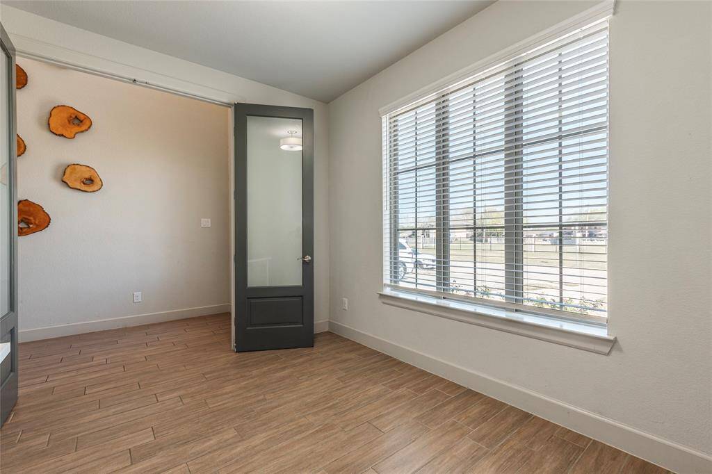 Photo of office in front of house. All living areas have wood tile floors. You will instantly love.