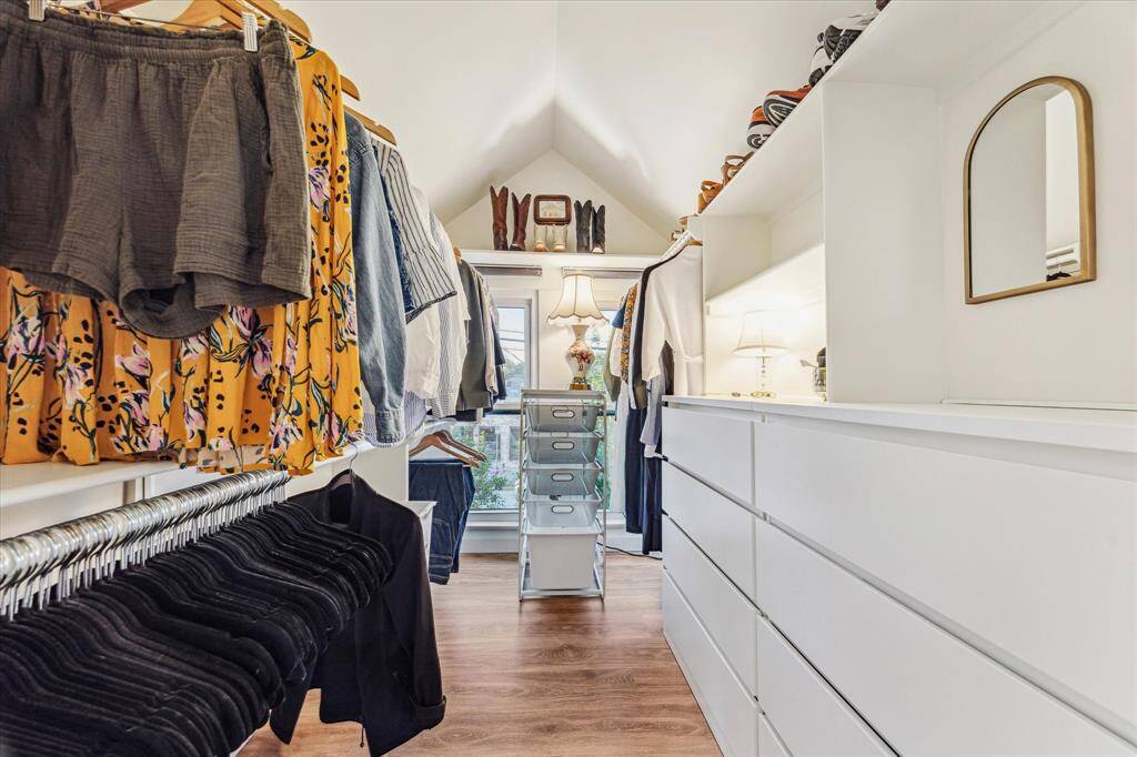 A custom primary closet with plenty of hanging space, built in storage and shelving. A space sure to be appreciated!