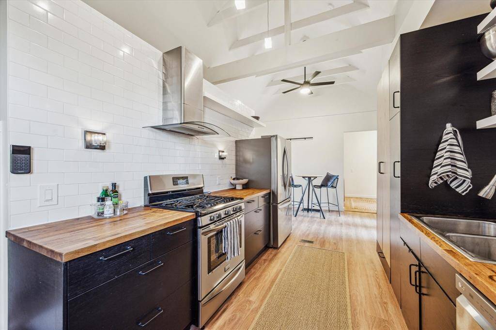 Alternate view of kitchen with view into breakfast area.