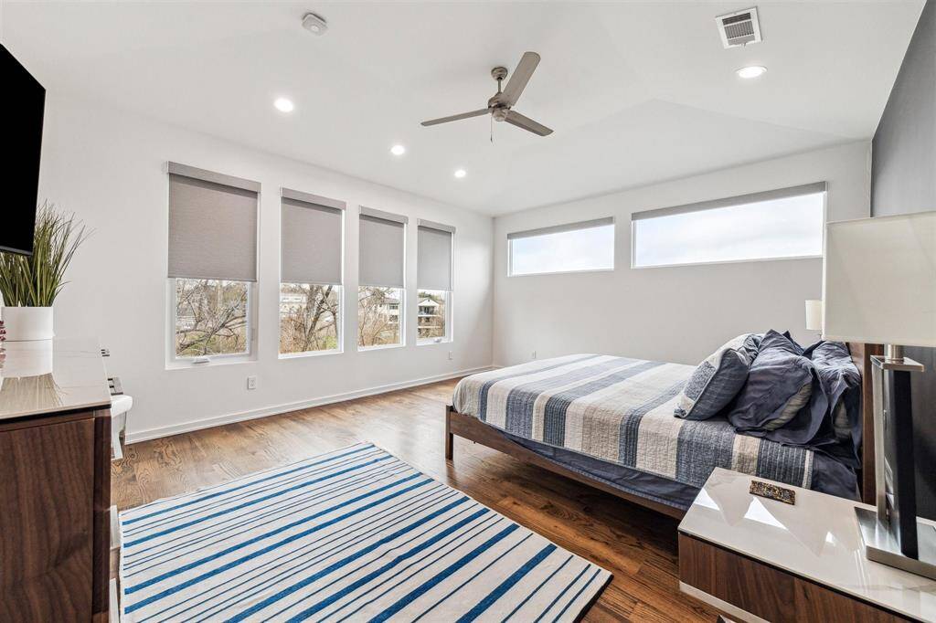 Serene master bedroom featuring new smart rechargeable room darkening shades for ultimate comfort and privacy.