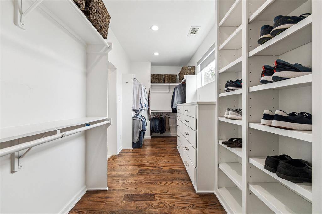 Expansive walk-in closet with custom shelving, offering ample storage and an organized, stylish design.