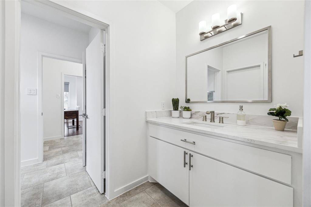 Elegant bath with a chic new counter and modern sinks, creating a fresh, stylish retreat.