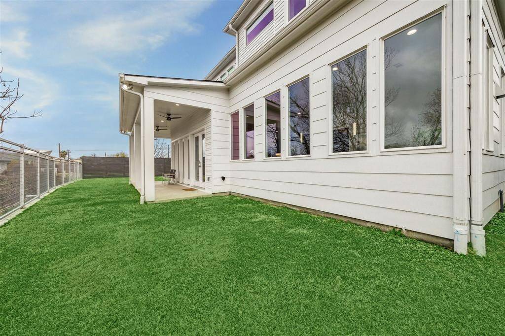 Private backyard with a sleek new metal fence and lush St. Augustine sod, perfect for relaxation.