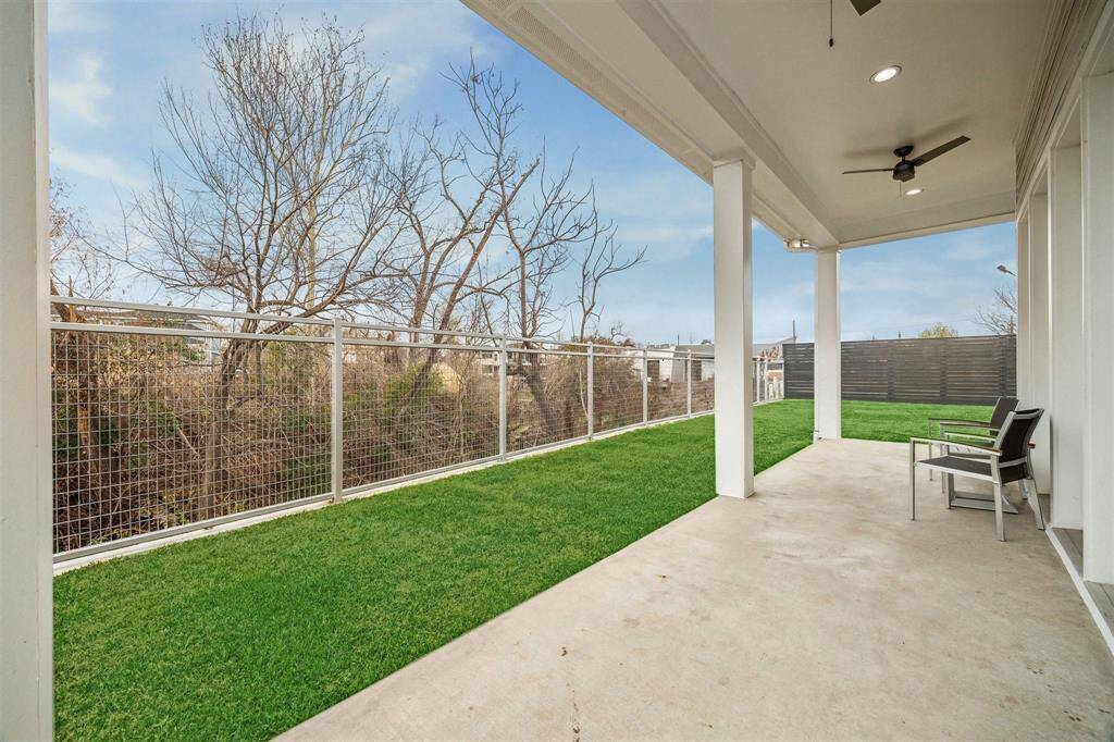 Spacious backyard with a sleek new metal fence, offering privacy and a modern, secure boundary.