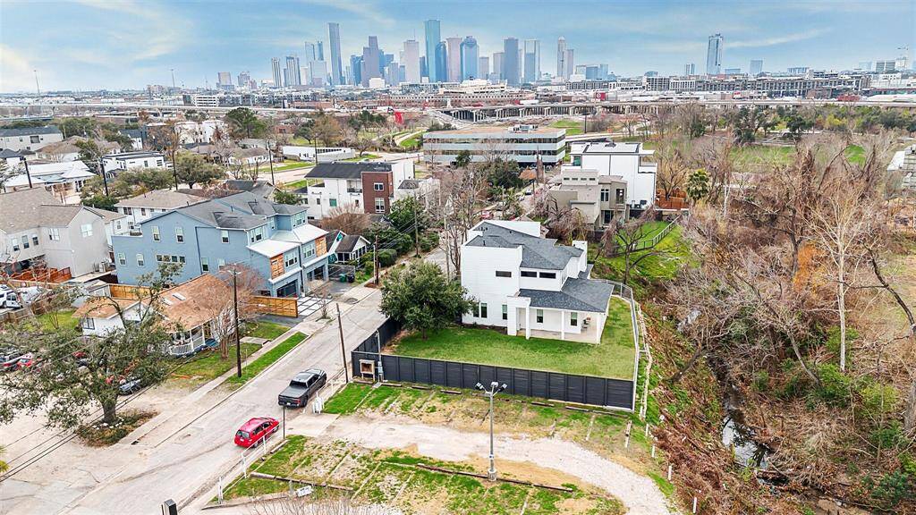 Breathtaking aerial view of this expansive 10,000 sq ft property, showcasing its grand scale and lush surroundings.