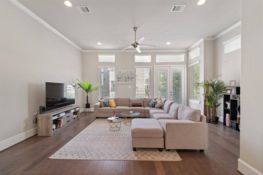 Living room flows from the kitchen leading to the outdoor balcony.