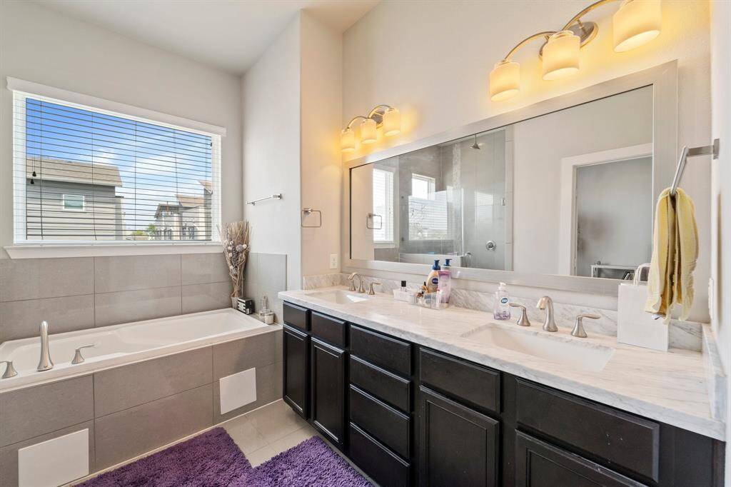 Primary bathroom featuring a separate shower and jetted tub.