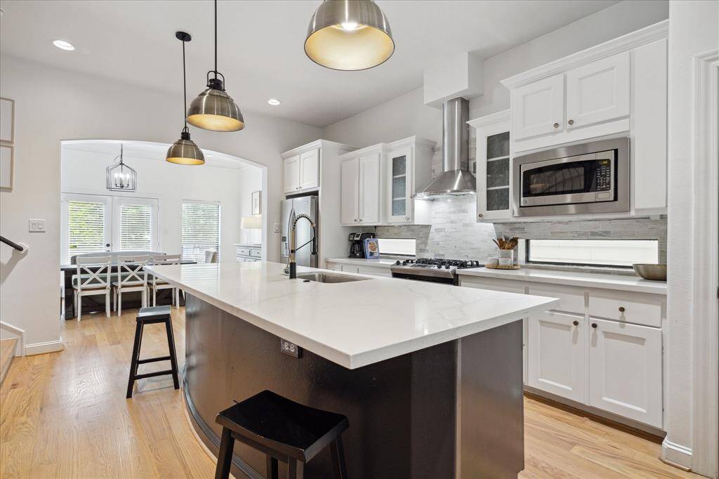 Stunning kitchen with quartz counters and stainless appliances.
