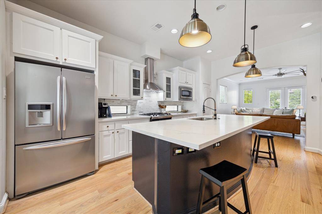 The large island makes it easy for family to be together in the kitchen.  If entertaining, it's a great space for a delicious buffet!