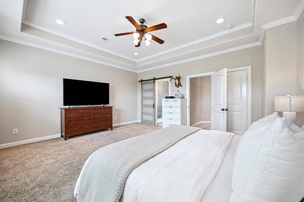 Easy to see how much wall space there is from this angle.  The door on the far right is to the second closet in this primary suite. The sliding door leads to the bathroom.