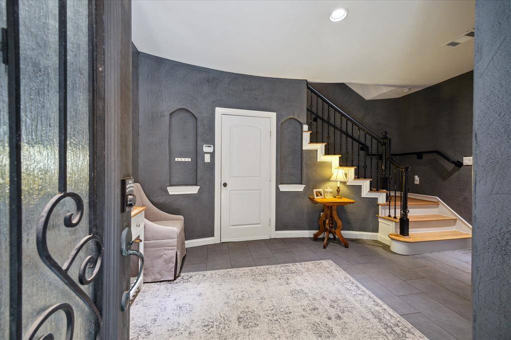 Come on in! Grand entryway to welcome your friends and family. The door shown leads to the two-car garage.