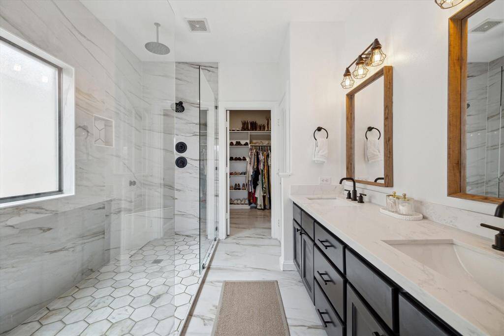 Double sinks, quartz counters and the double shower are highlights of the primary bathroom.