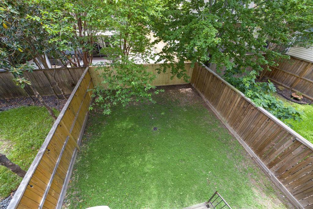 Taken from the balcony above, you really get a sense of the size of the yard!  And with the fence recently replaced on all three sides, it's a ready and waiting blank canvas for you to create the perfect backyard paradise!