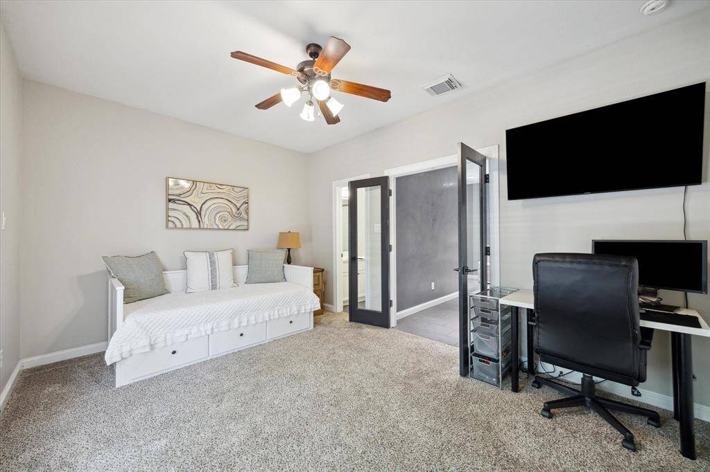 Located on the first floor, this bedroom and en suite bath is ideal for guests or a roommate scenario. It also serves well as a home office.