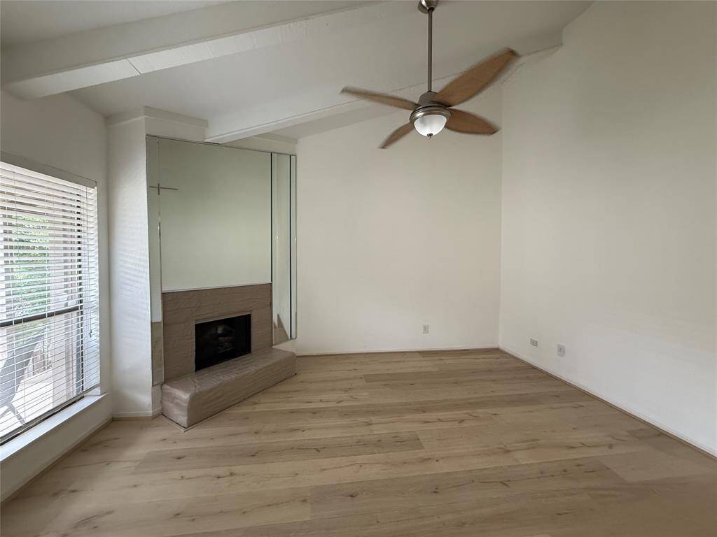 Spacious living room with vaulted ceilings and fireplace.