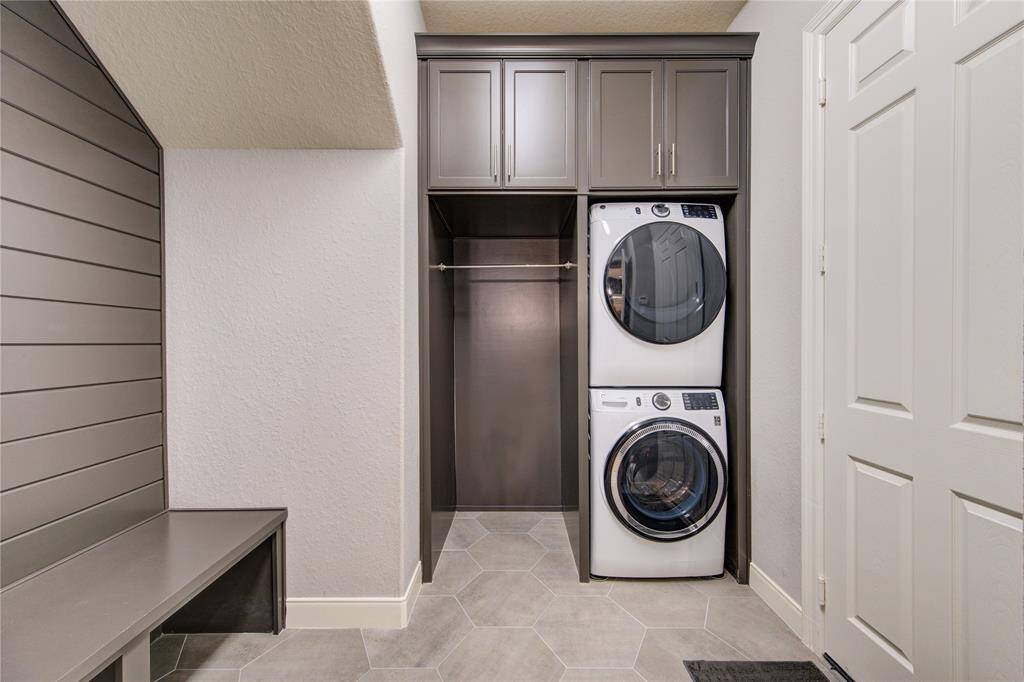 This thoughtfully designed laundry room includes built-in cabinetry and functional elegance—tailored for both beauty and utility