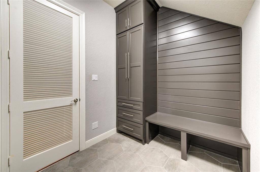 Crisp finishes, custom storage and thoughtful details make laundry day a little more luxurious