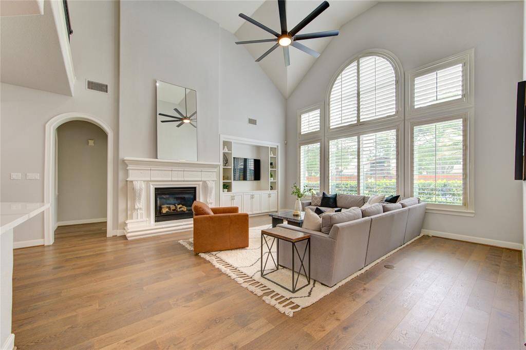 Soaring ceilings, expansive windows and a stunning fireplace anchor this grand yet cozy living space
