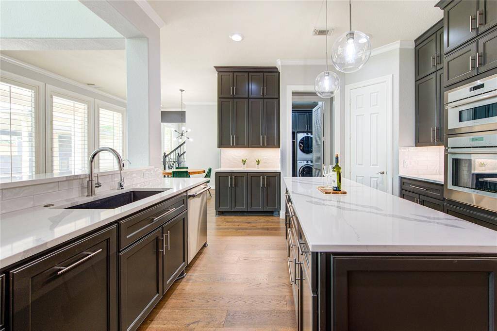 Quartz countertops, custom cabinets and a large island offer both style and function in this culinary space