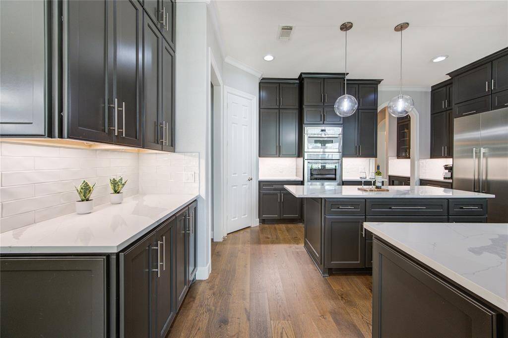 Custom cabinets, under-cabinet lighting and thoughtfully placed details make this kitchen as practical as it is beautiful