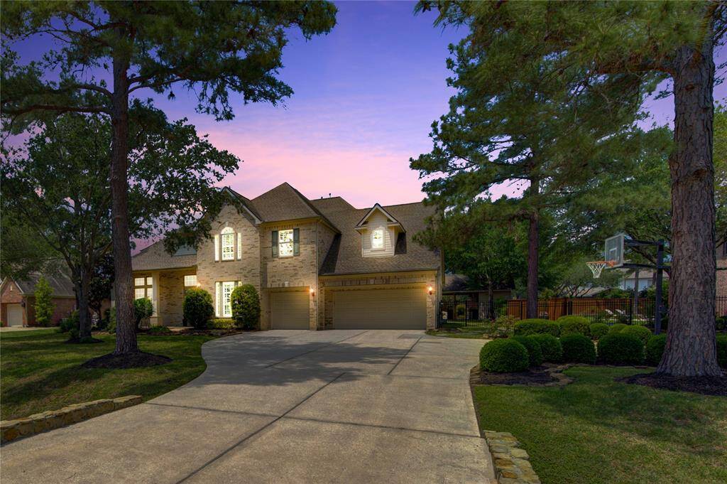 Captivating twilight view of this exquisite residence, where elegant architecture offering a warm, welcoming glow at sunset