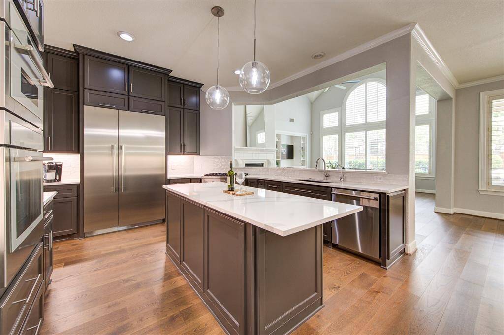 Chef-worthy kitchen with updated stainless steel Thermador appliances, quartz counters, custom cabinetry and a spacious island—crafted for culinary excellence