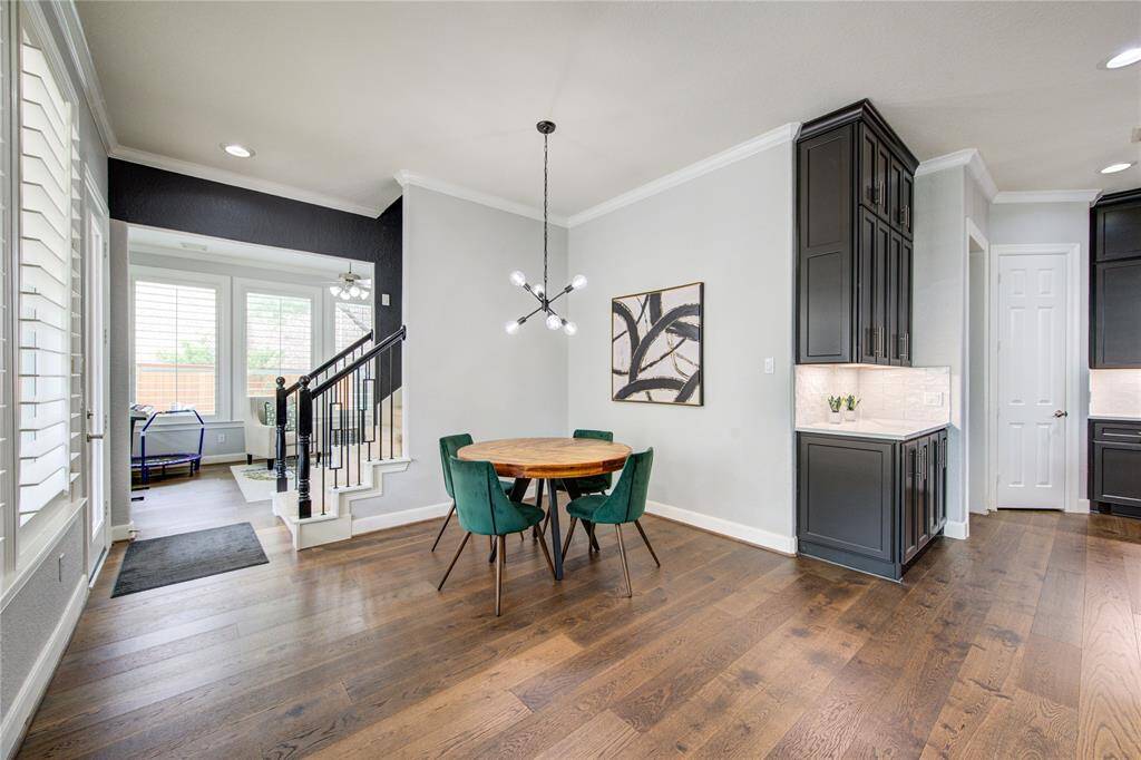 Enjoy your morning coffee bathed in natural light from a wall of oversized windows with plantation shutters